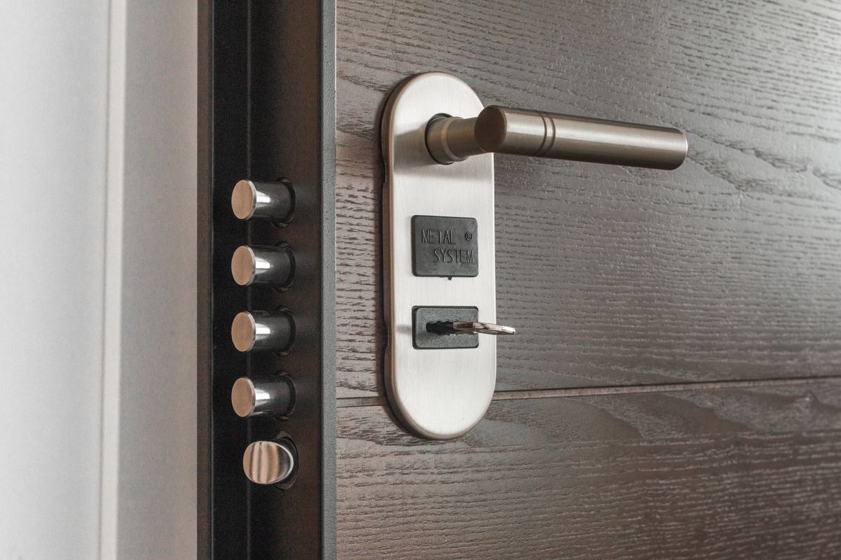 Padlock with a key inserted on a dark wooden background
