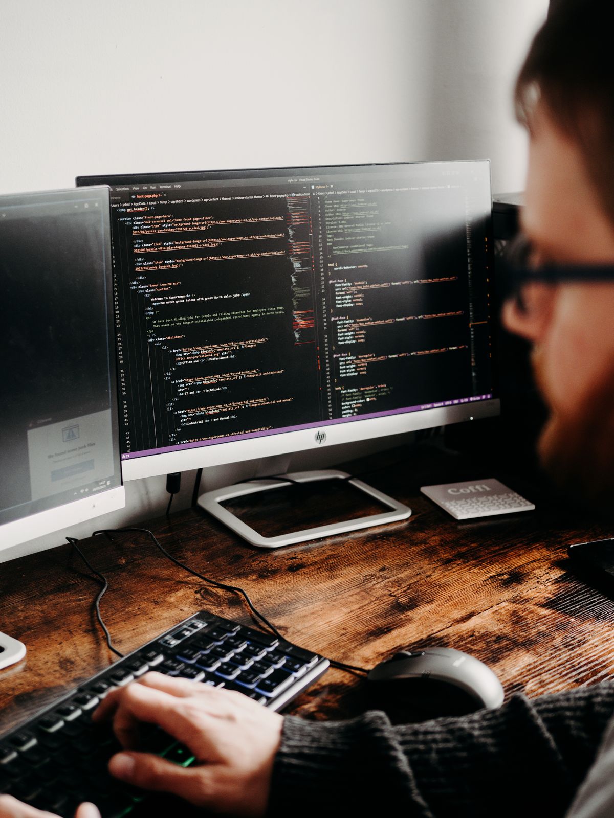 A developer working across multiple code screens