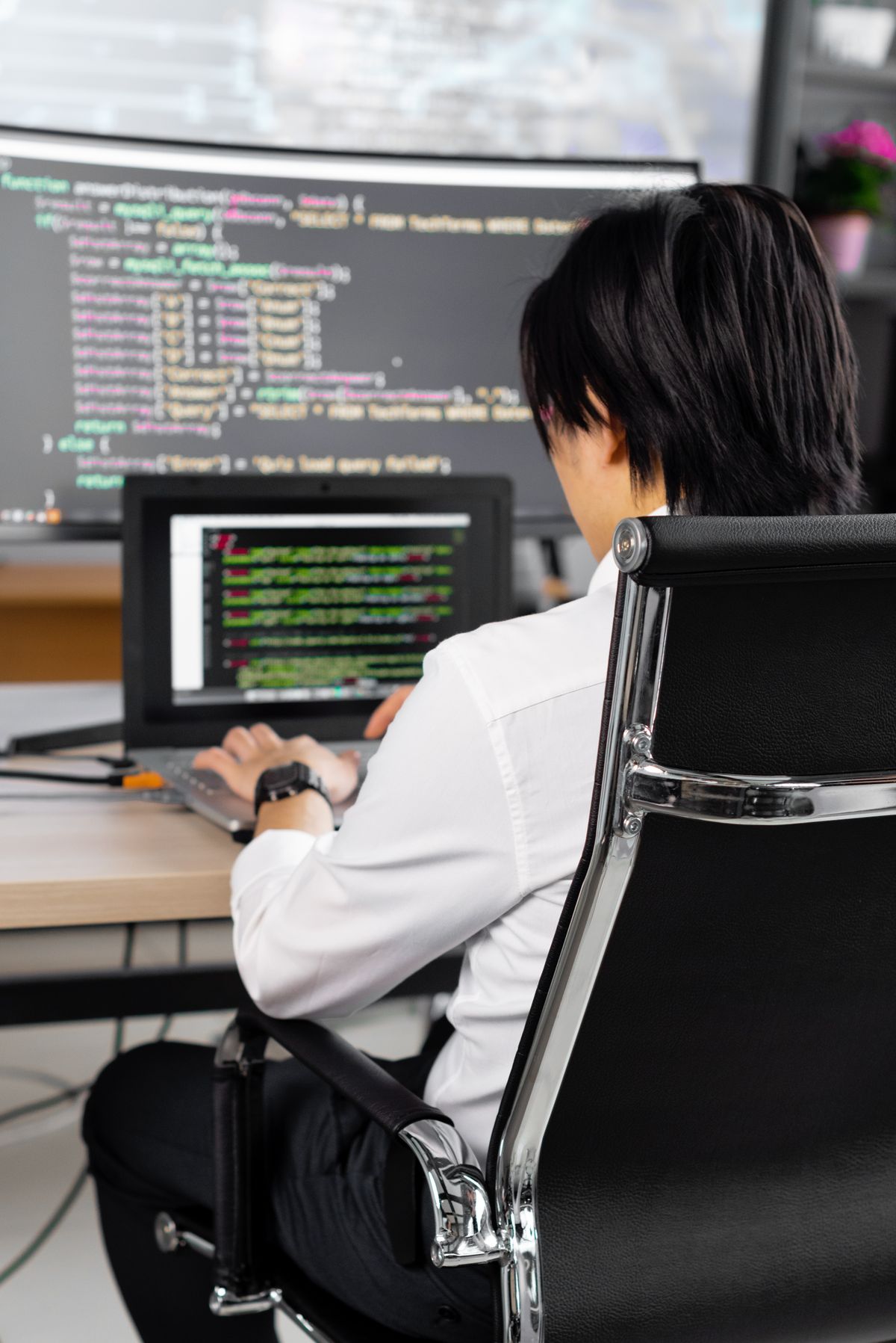 A software engineer writing code at a desk