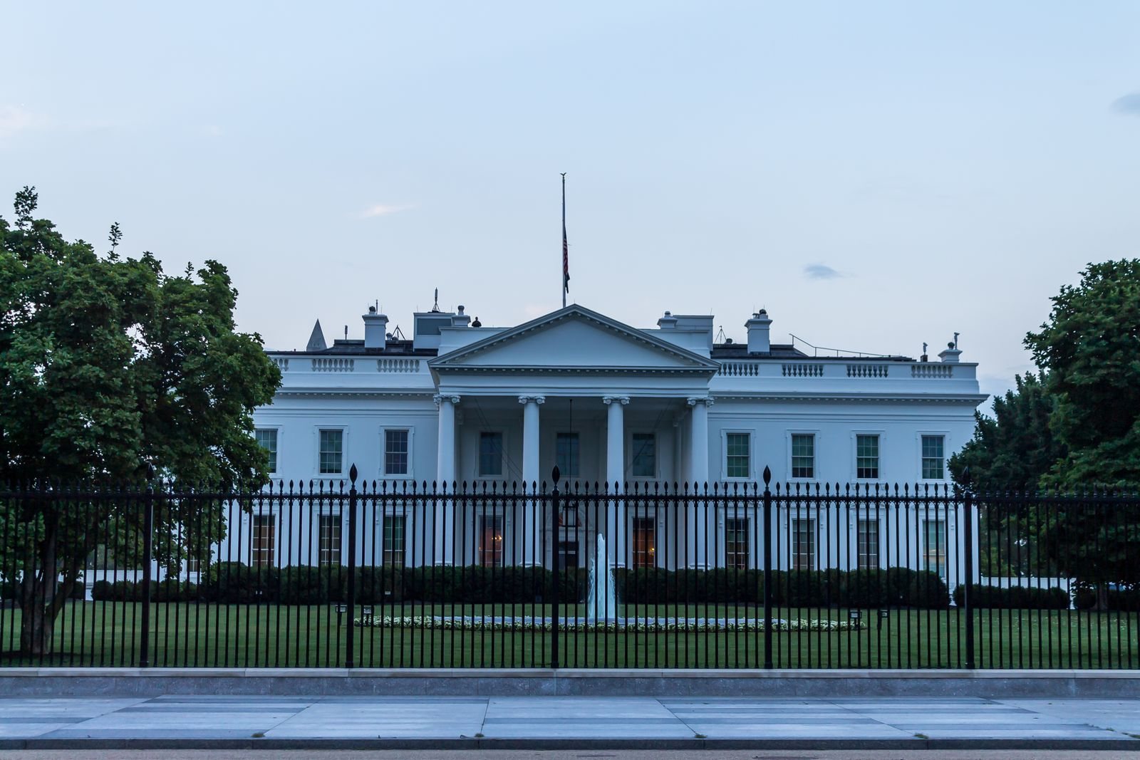 Front of the White House in Washington D.C. behind its iron fence — where the order renaming AI to SI was issued